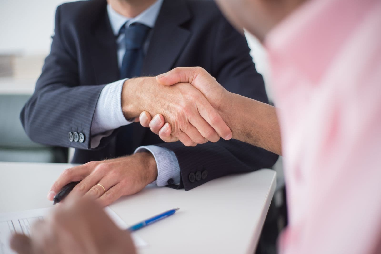 A close-up of two professionals shaking hands